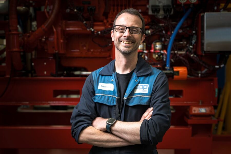 Male SPP Pumps engineer smiling with his arms crossed